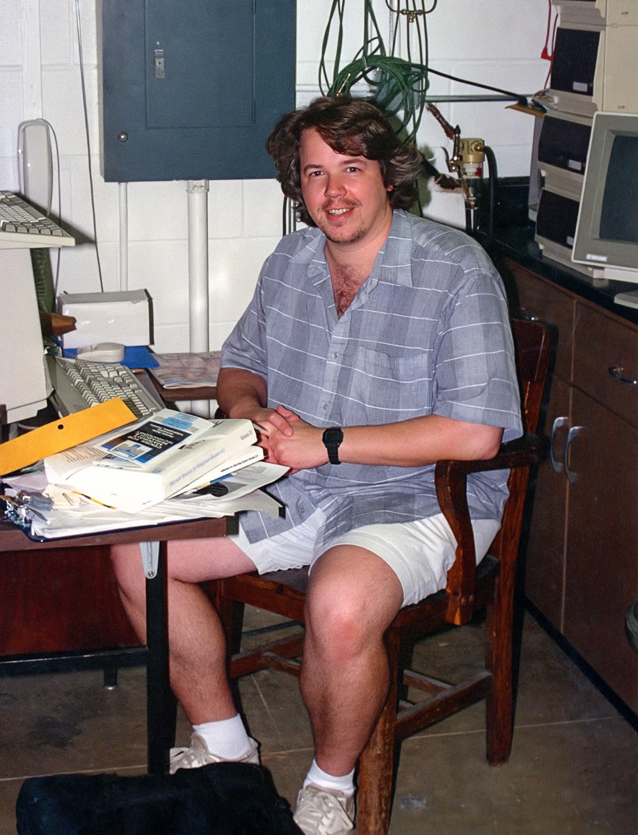 Joe working at a wooden desk early on in his career